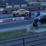 Two drag cars staged side by side at a speedway starting line