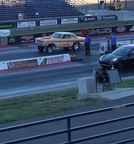 Two drag cars staged side by side at a speedway starting line